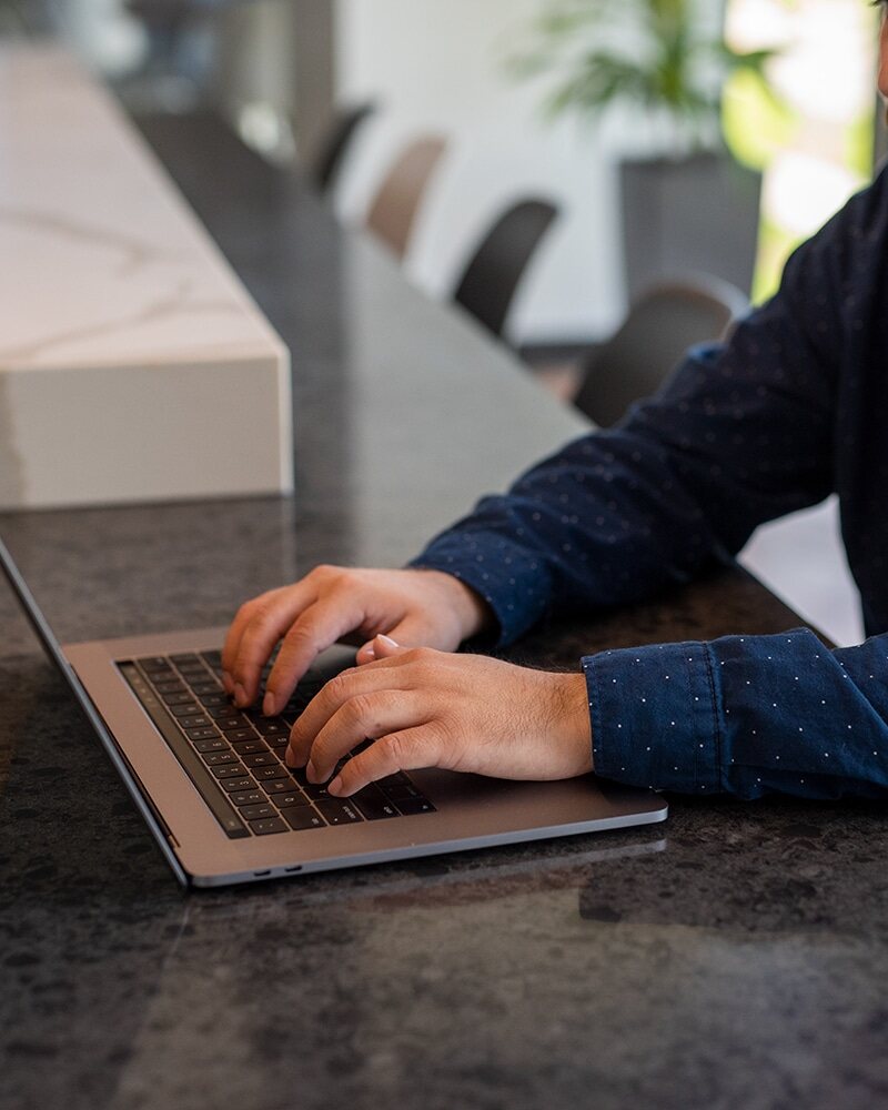 Found  employee typing on laptop