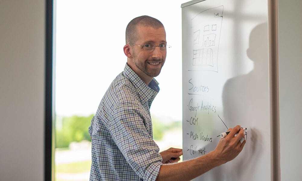 Ryan Eme at marker board